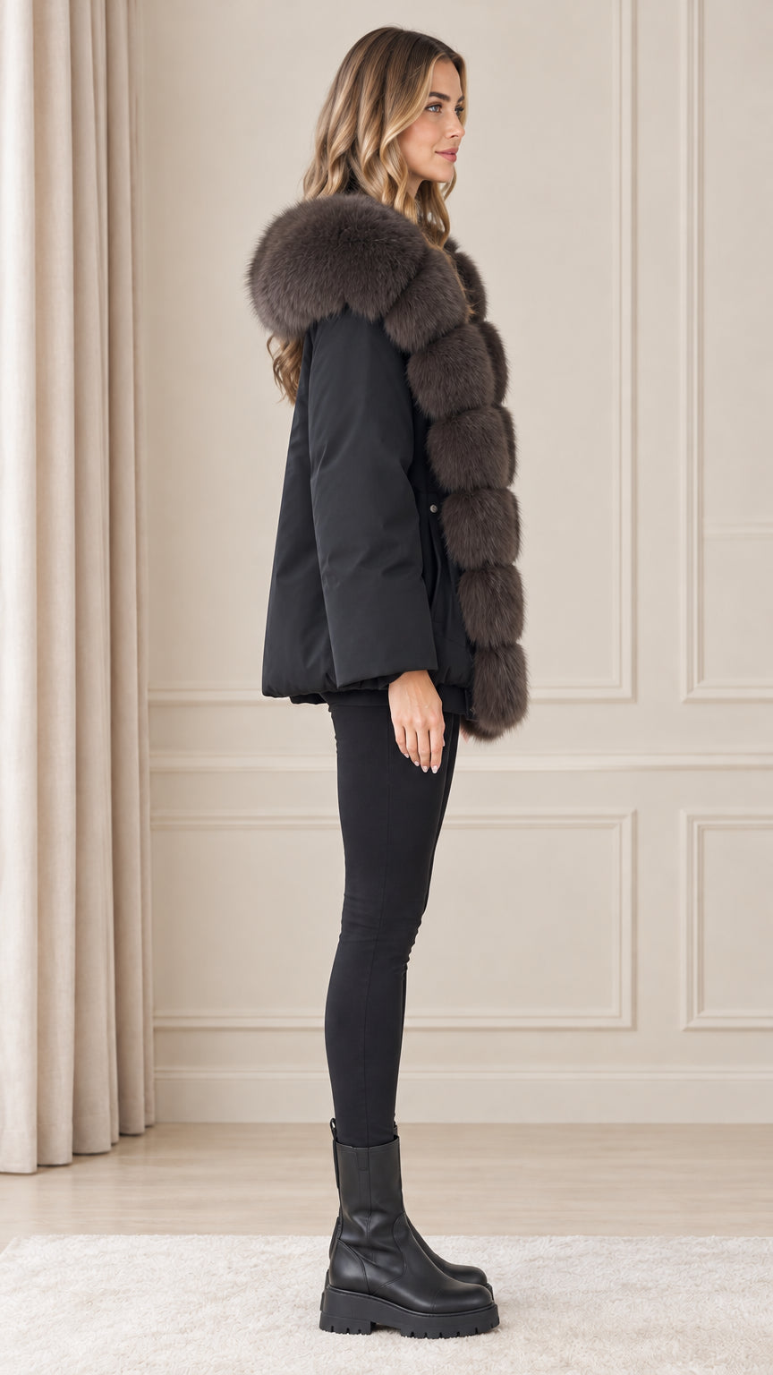 Side profile of model wearing black hooded parka jacket with plush trim