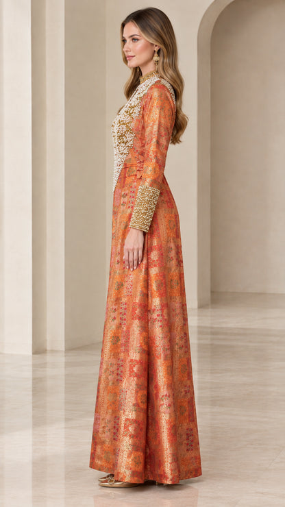 Side profile view of rust orange pearl-embellished long sleeve gown