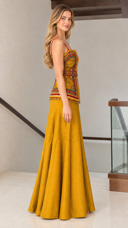 Side profile of woman wearing mustard yellow embroidered two-piece wide-leg set