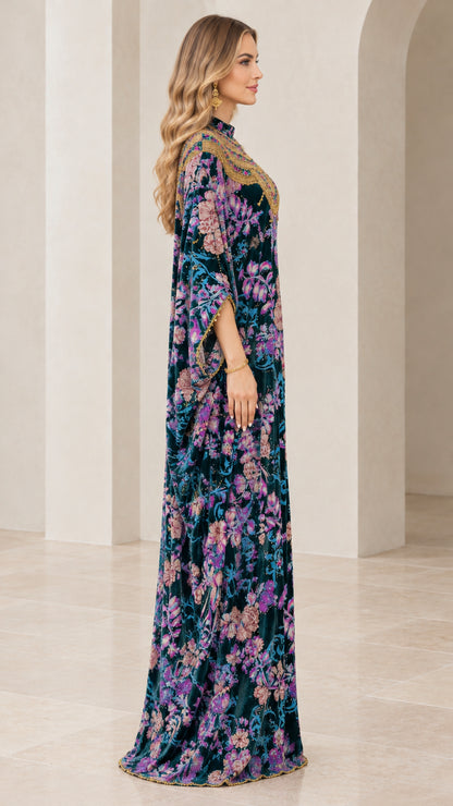 Side profile view of teal floral velvet kaftan showing draped sleeves