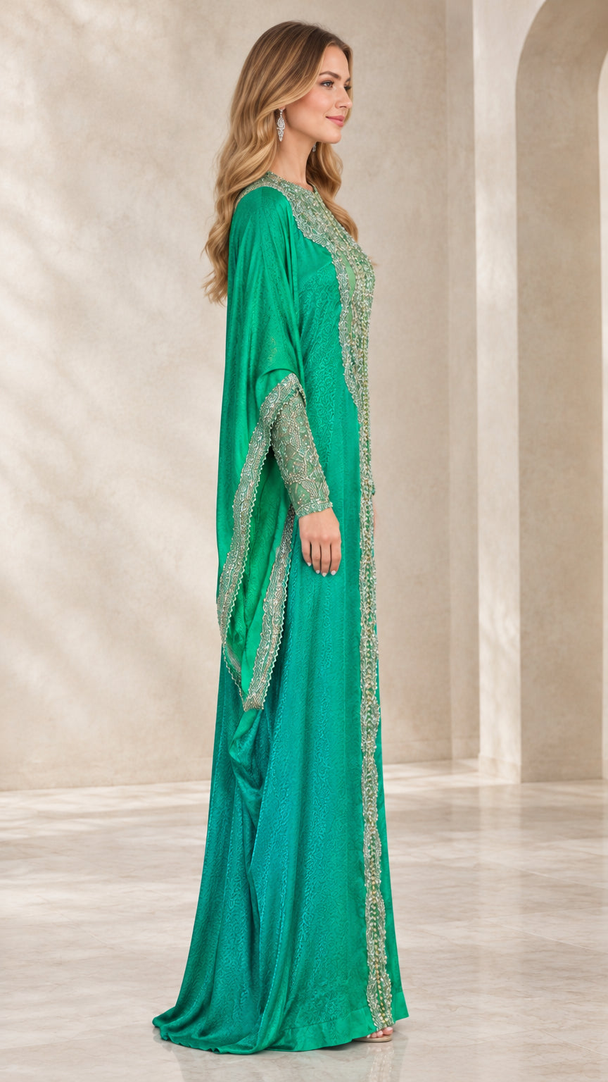 Side profile of emerald green flowing kaftan gown with draped cape sleeves