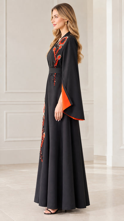 Side full-length view of woman in Black embroidered long formal gown
