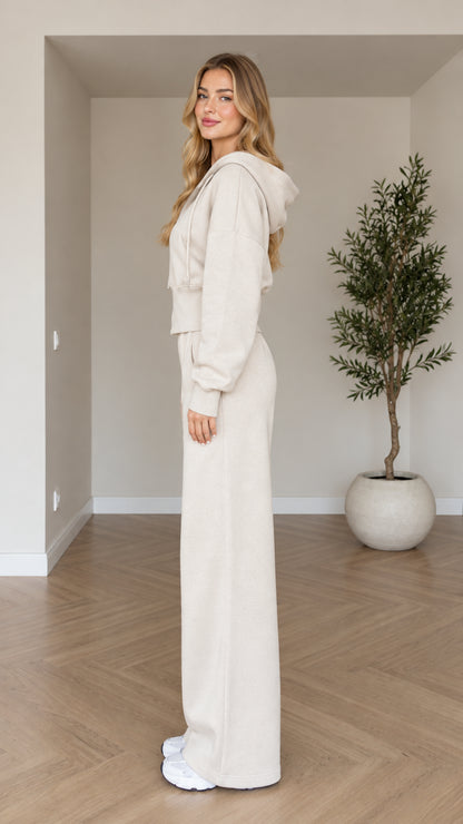 Side profile view of woman modeling beige two-piece loungewear set