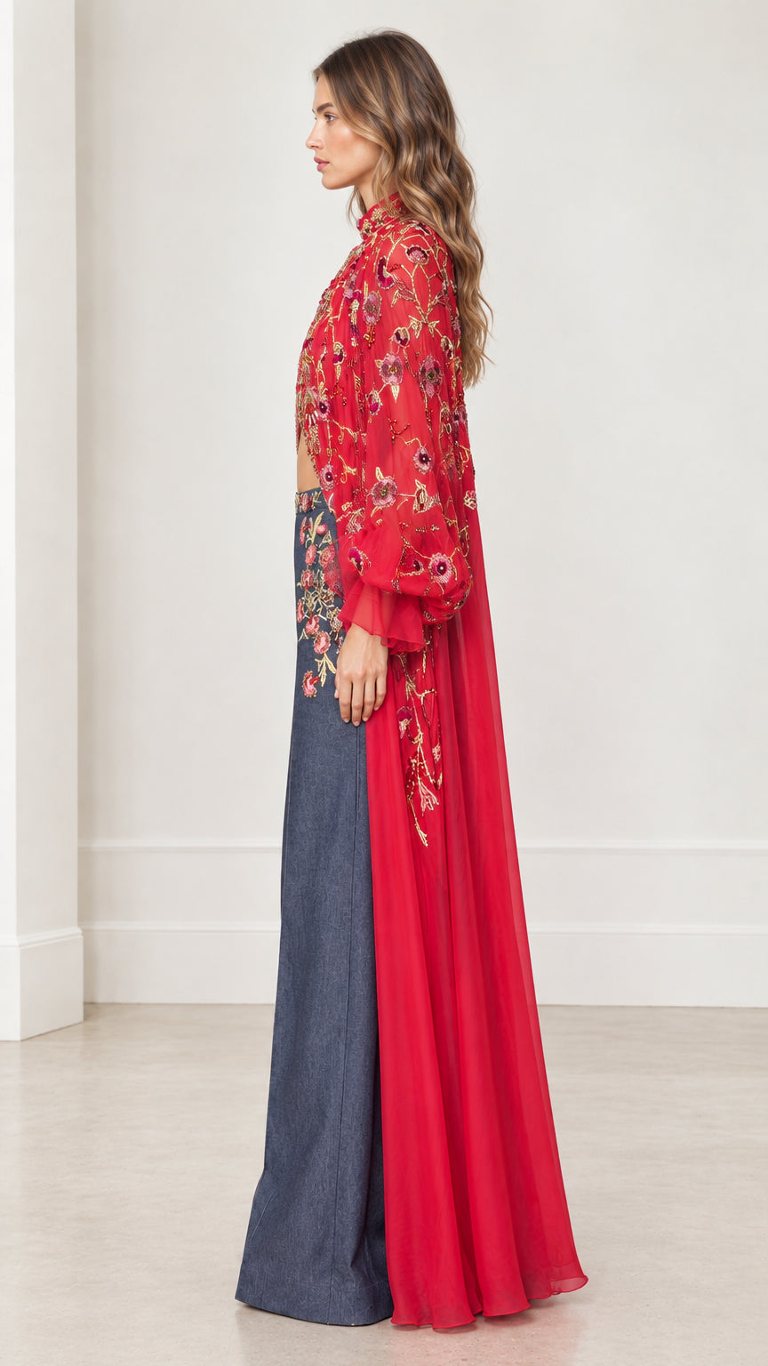 Side profile view showing dramatic flow of red chiffon embroidered cape duster