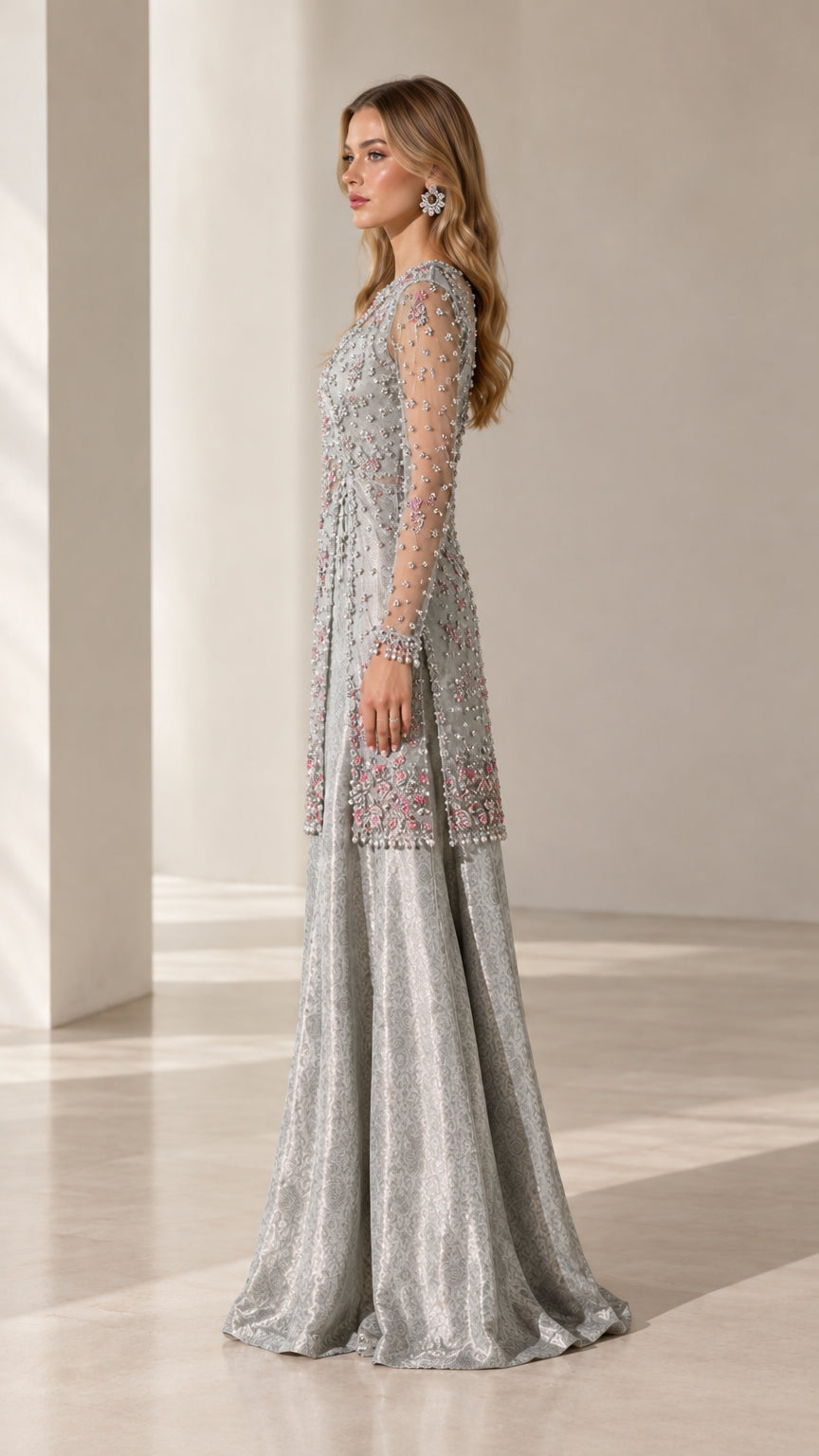 Side profile view of silver beaded longline tunic and flowing formal pants