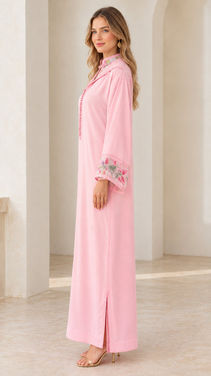 Side profile of pink embroidered hooded kaftan dress showing side slit
