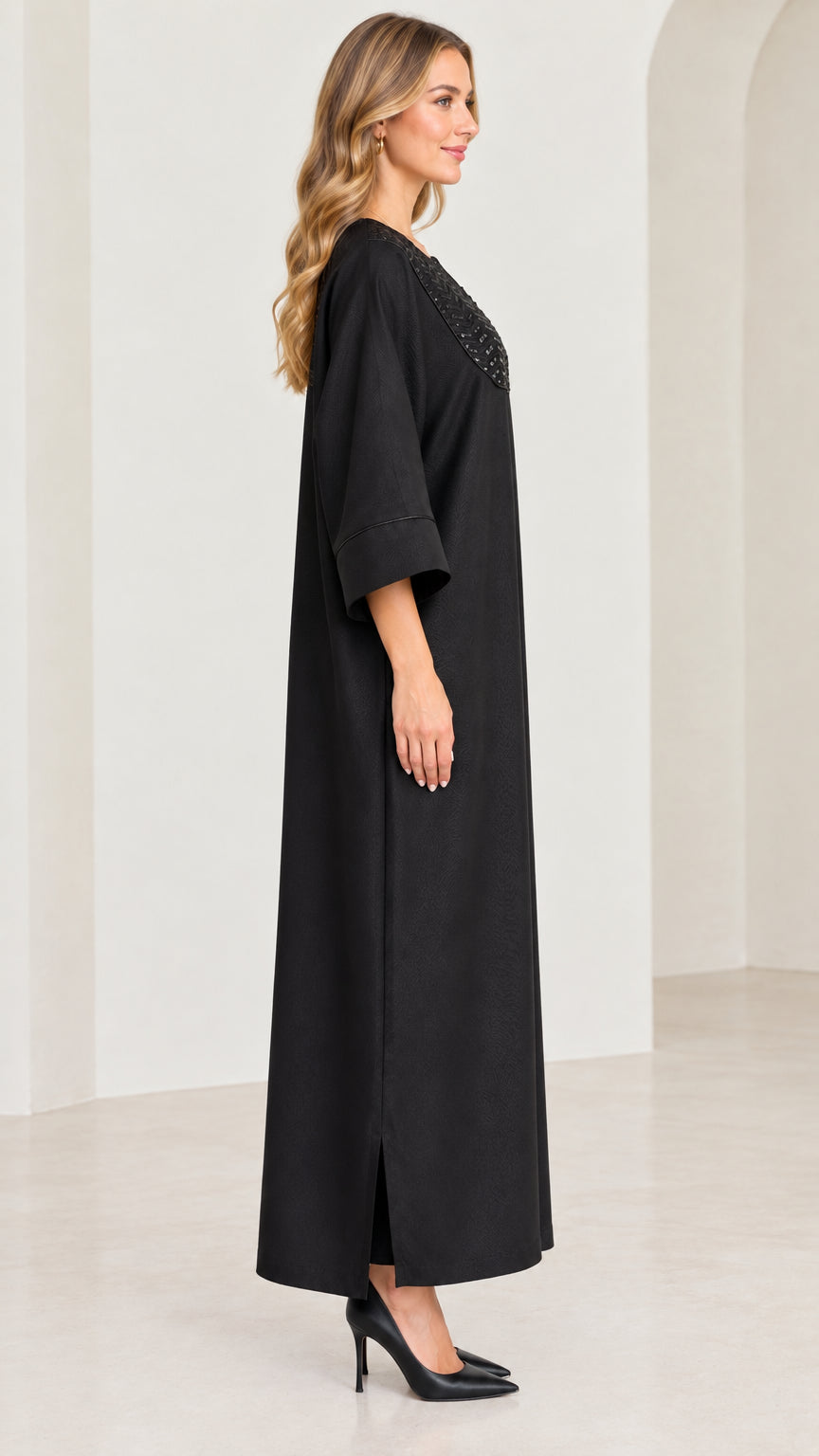 Side profile view of black relaxed kaftan maxi dress with side slit