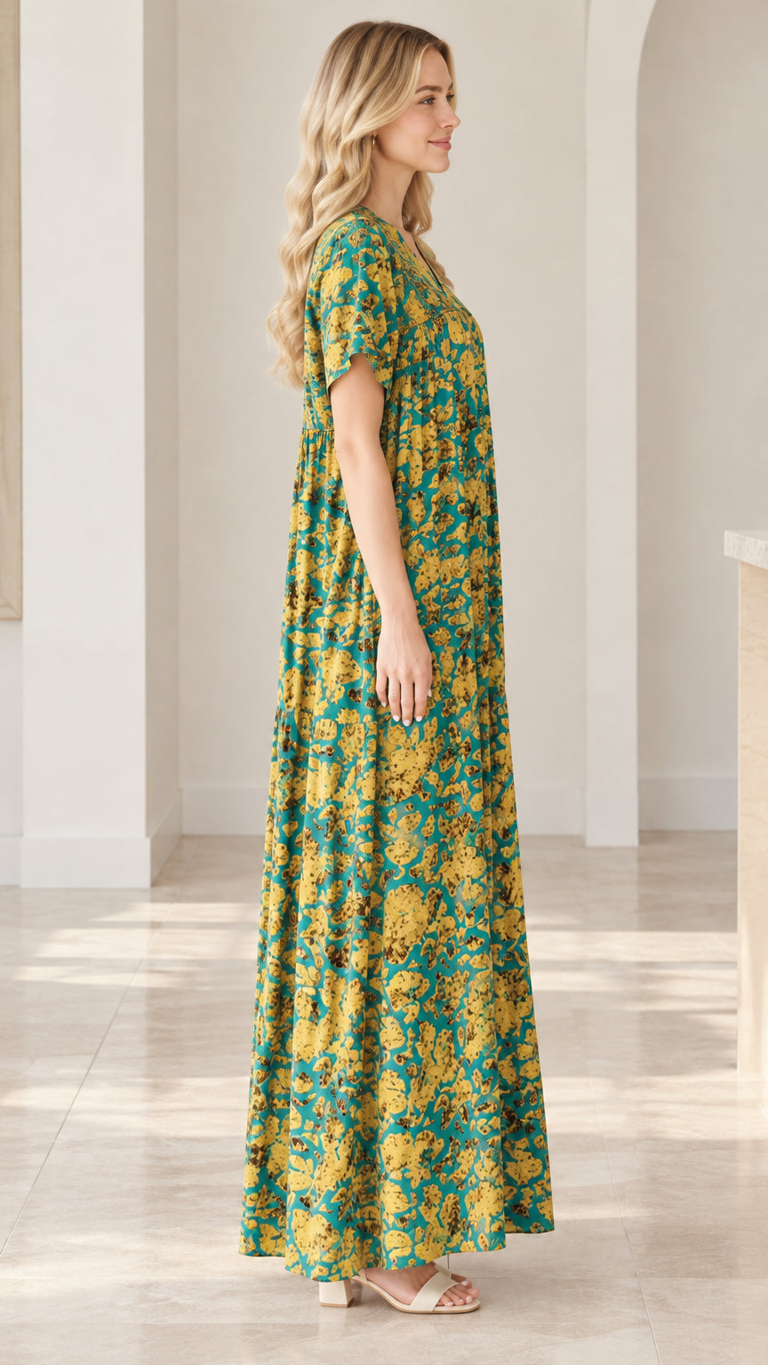 Side profile view of teal floral short sleeve relaxed fit maxi dress