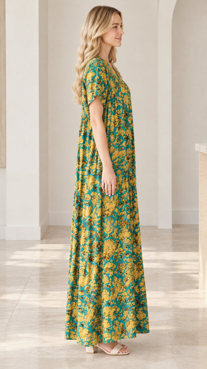Side profile view of teal floral short sleeve relaxed fit maxi dress