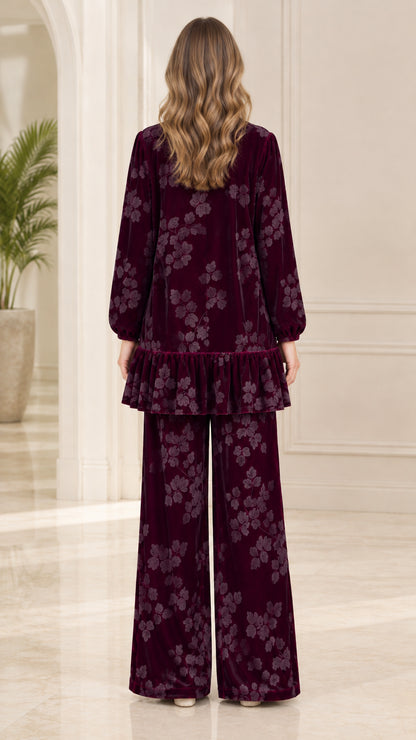 Back view of model showing burgundy floral velvet long tunic and matching pants