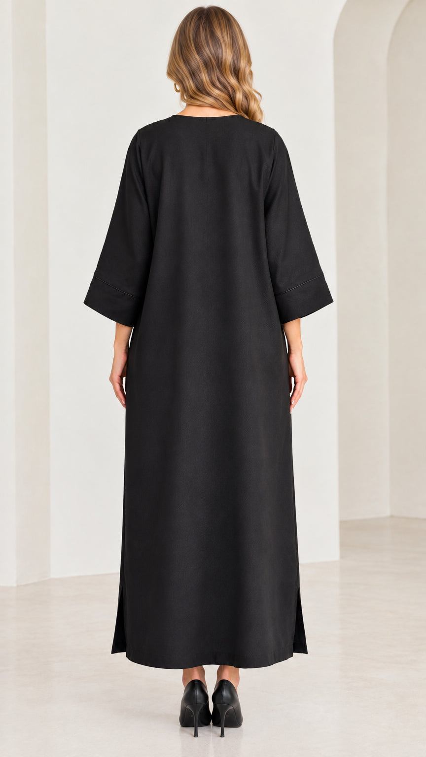 Back full-length view of black kaftan dress showing smooth drape