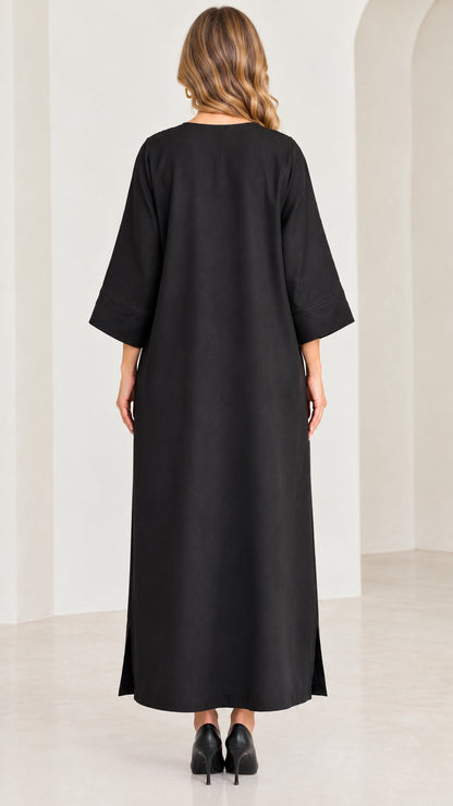 Back full-length view of black kaftan dress showing smooth drape