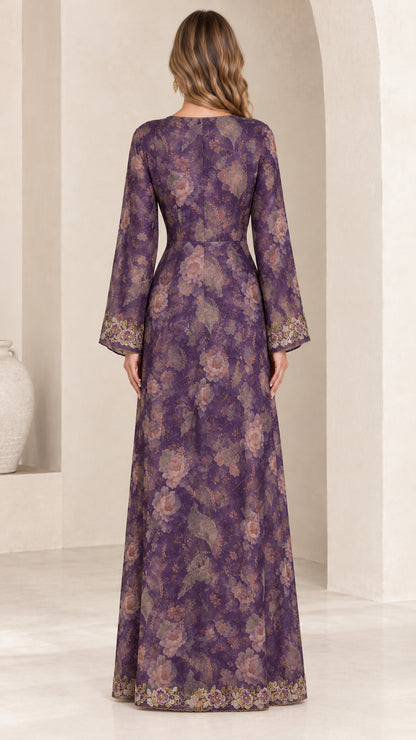 Back view of woman wearing purple floral print maxi gown