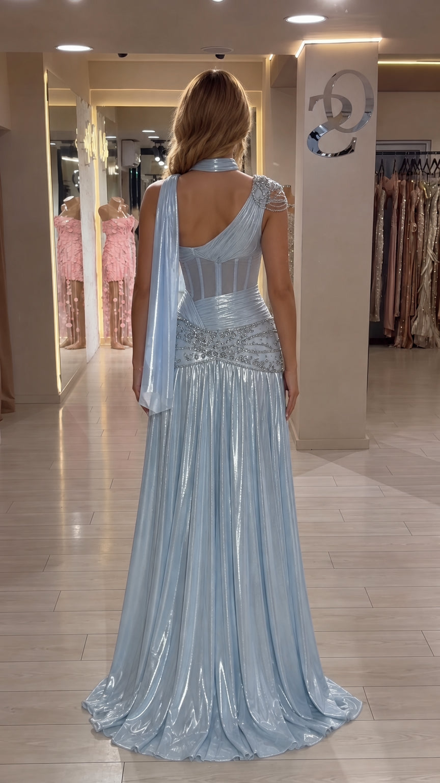 Back view of Ice Blue evening gown showing sheer boned corset and draped cape