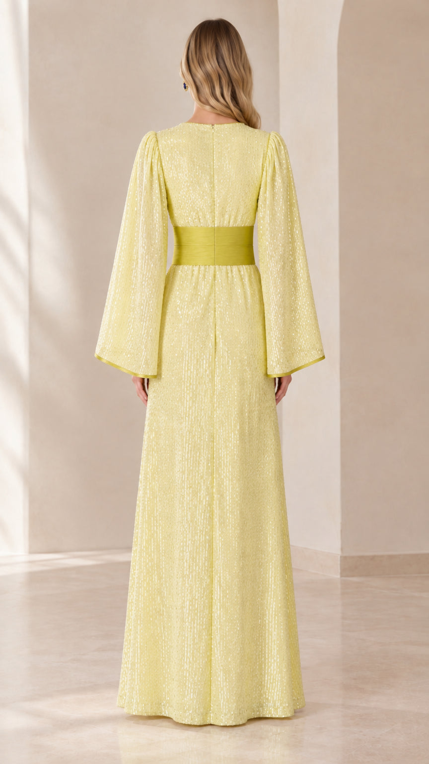 Back view of woman wearing pastel yellow sequin floor-length kaftan dress