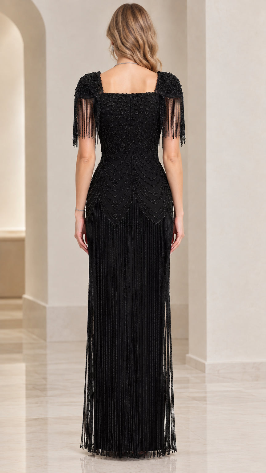 Back view of black beaded maxi gown with square neckline and full-length fringe