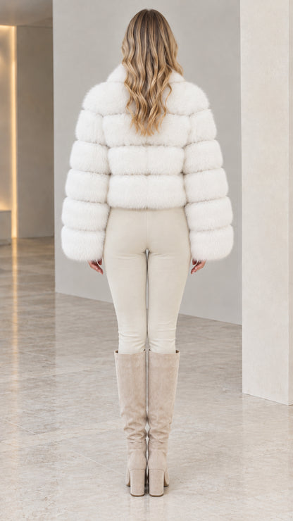 Back view of model wearing white tiered faux fur jacket showing cropped fit