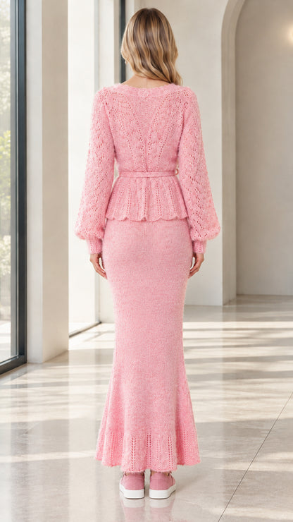Back view of woman wearing pink long sleeve knit peplum set and maxi skirt