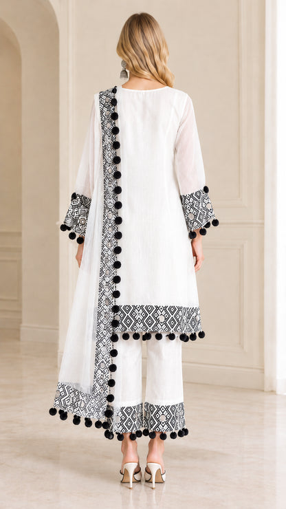 Back view of women's white tunic pants set with matching draped scarf