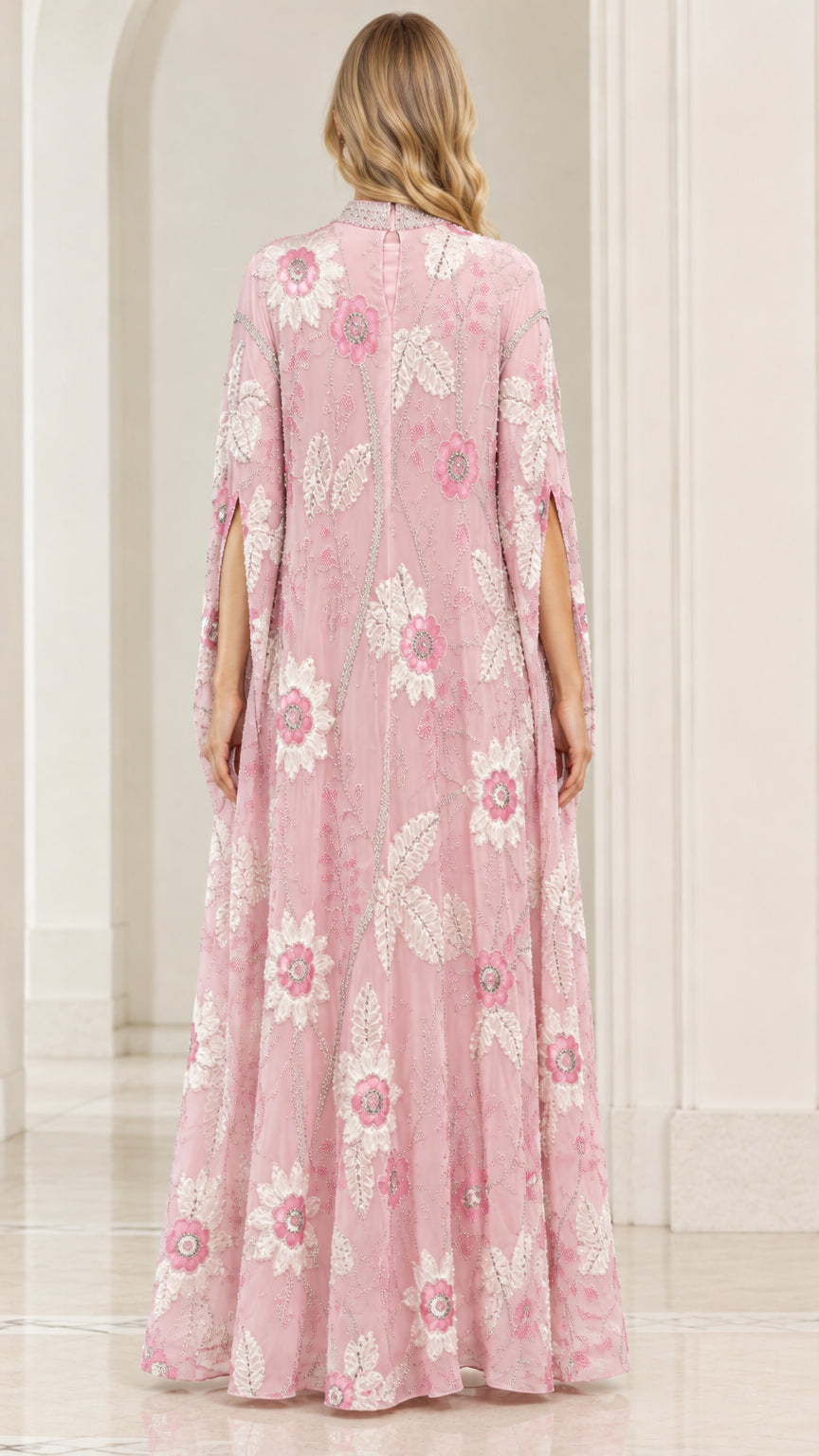 Back view of dusty pink floral cape gown showing long flowing drape