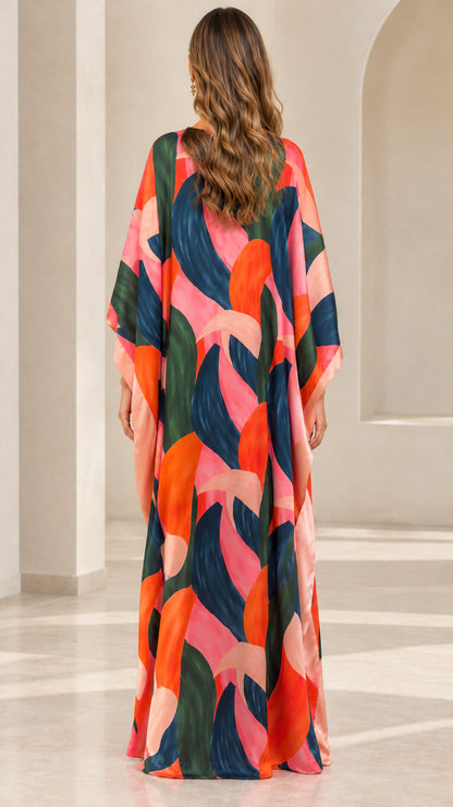 Back full-length view of woman in colorful brushstroke print kaftan dress