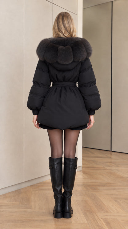Back view of black belted winter coat showing hooded faux fur trim