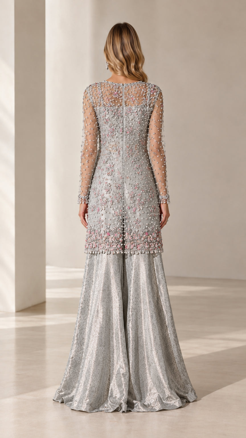 Back view of model in silver embellished long sleeve tunic and matching wide-leg trousers