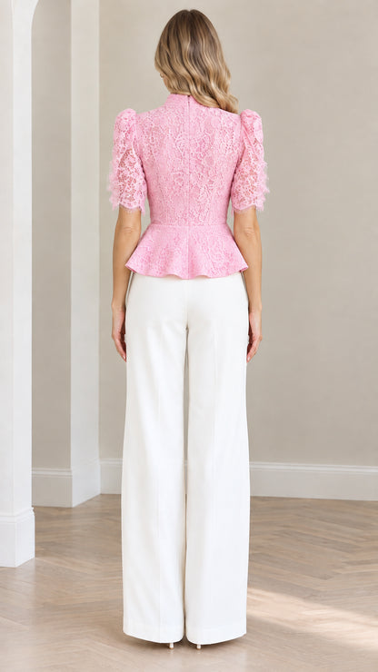 Back view of model wearing blush pink lace short sleeve peplum top