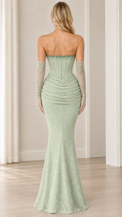 Back view of model in sage green strapless lace maxi gown with opera gloves