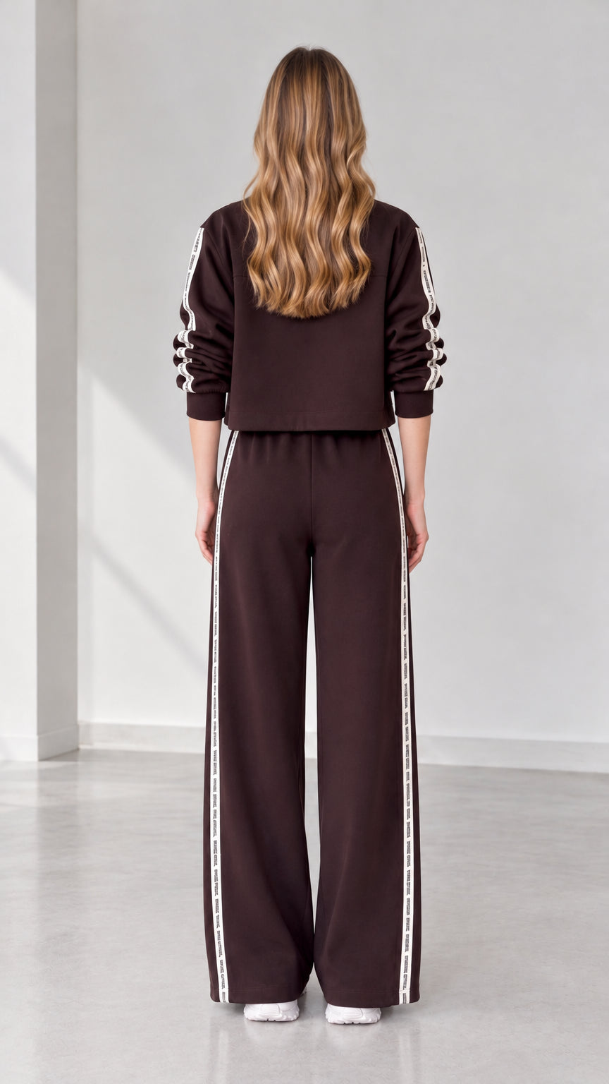 Back view of women's dark brown cropped jacket and wide-leg sweatpants set
