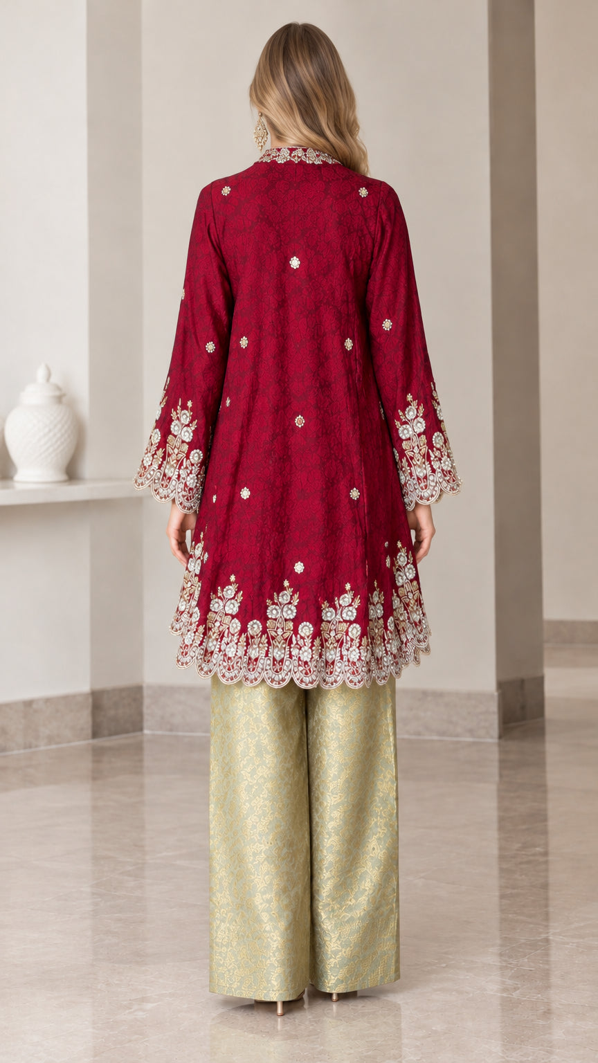 Back view of model wearing burgundy embroidered tunic top with scalloped hem