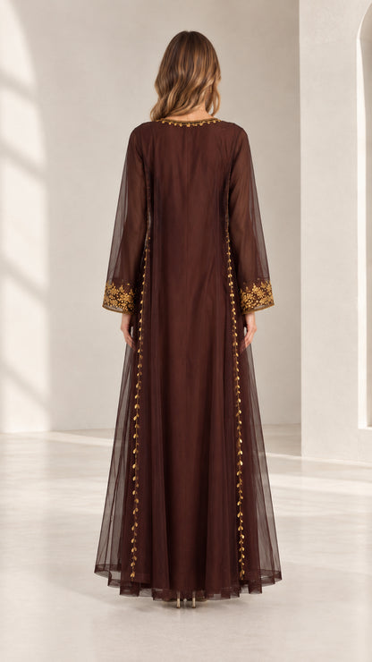 Back full-length view of woman wearing chocolate brown embroidered kaftan maxi dress