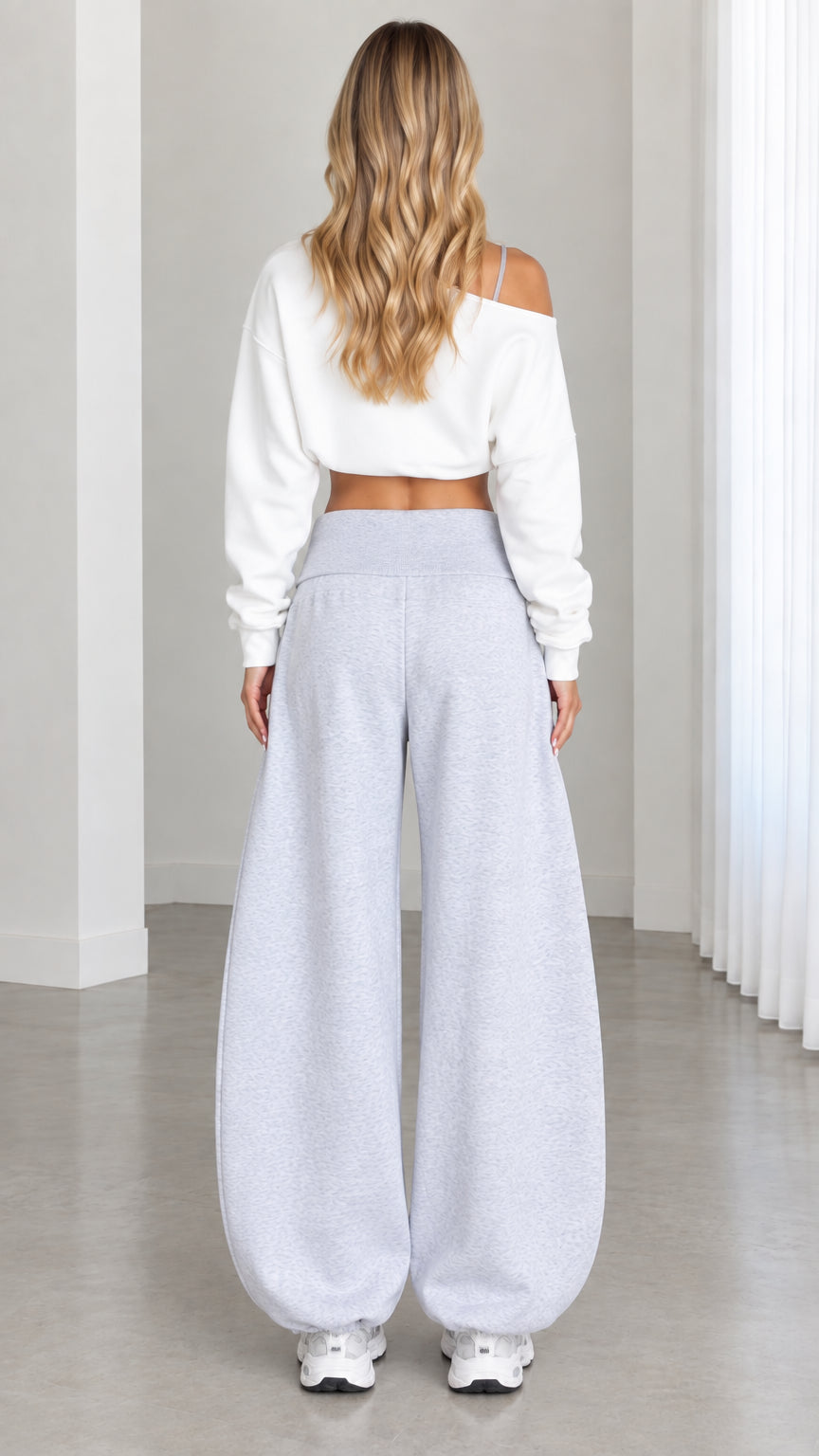 Back view of model wearing Heather Gray balloon sweatpants and white cropped long sleeve pullover