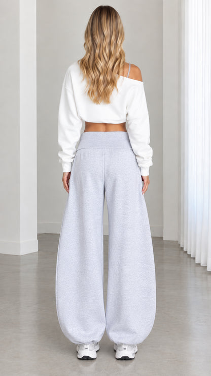 Back view of model wearing Heather Gray balloon sweatpants and white cropped long sleeve pullover