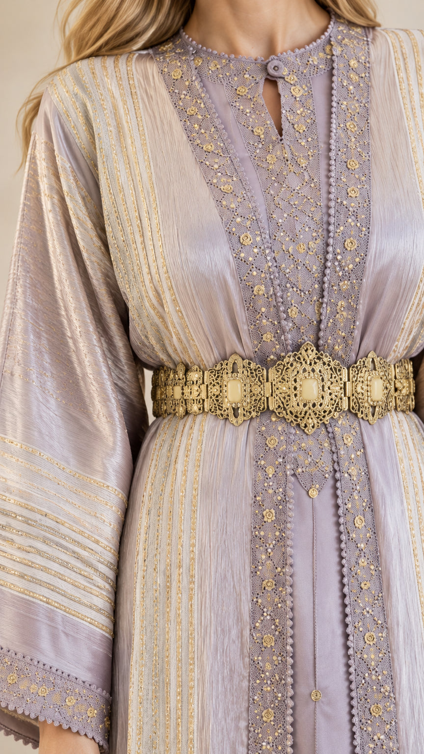 Close up of gold embroidery, notched neckline, and metallic belt on lavender dress