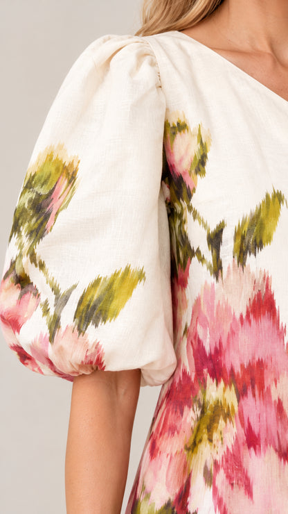 Close-up detail of textured woven fabric and dramatic puff sleeve
