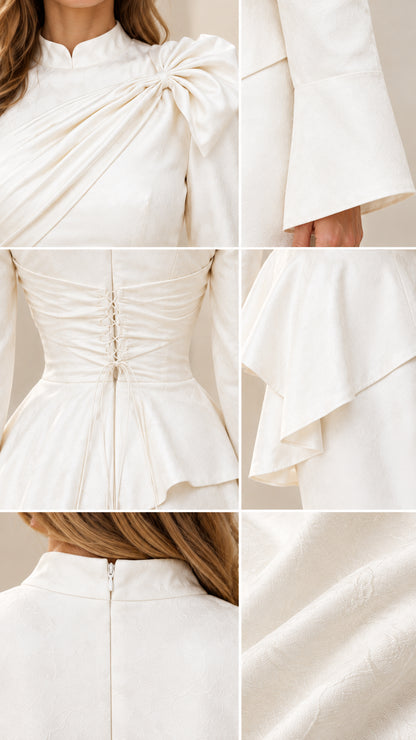 Close-up details of draped shoulder neckline, peplum waist, and fabric texture