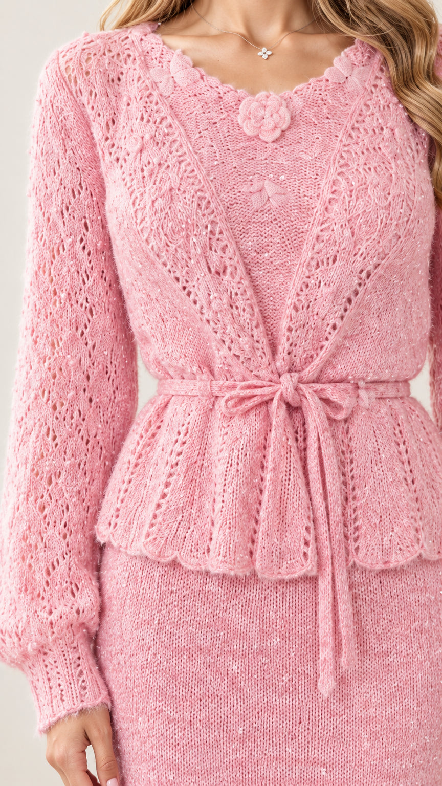 Close up of pink crochet knit detail with rosette accent and tie waist