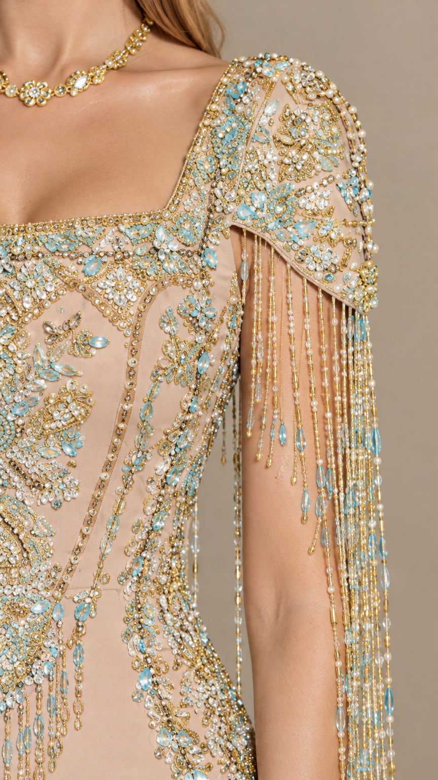 Close-up detail of intricate crystal beadwork and shoulder fringe tassels