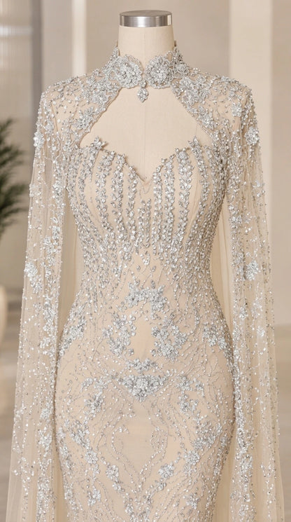Close-up of champagne sweetheart bodice with crystal embellishments and keyhole cape collar