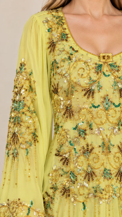Close-up detail of scoop neckline and ornate sequin beadwork on yellow dress