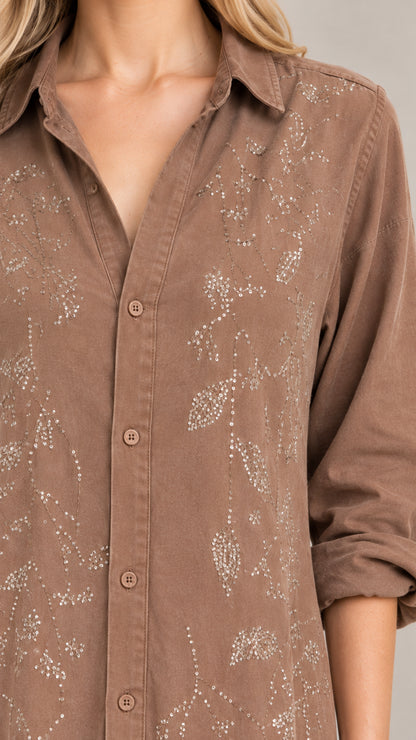 Close-up detail of botanical embroidery on collared shirt dress