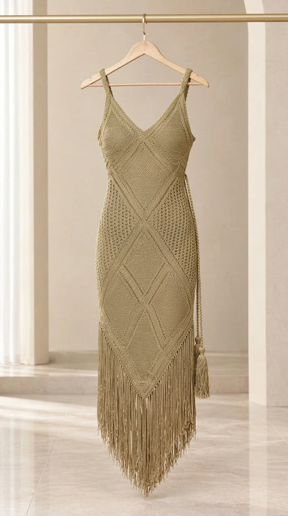 Olive green crochet knit dress with long tassel fringe hanging on wooden hanger