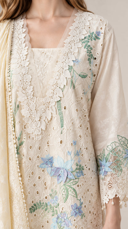 Close-up detail of cream embroidered neckline, floral cutwork, and lace border