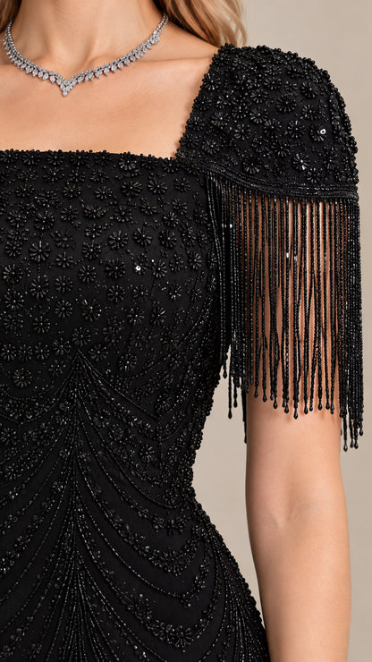 Close-up detail of black beaded bodice and cascading fringe shoulder trim