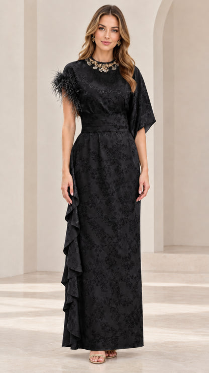 Model wearing black embellished floral jacquard formal maxi gown with feather accent