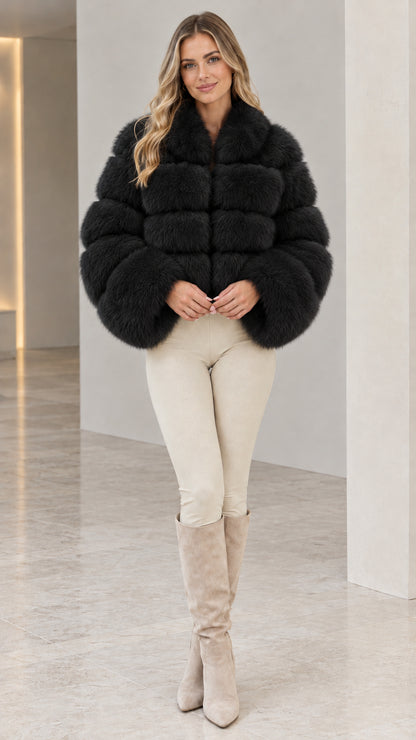 Model wearing black cropped tiered faux fur jacket