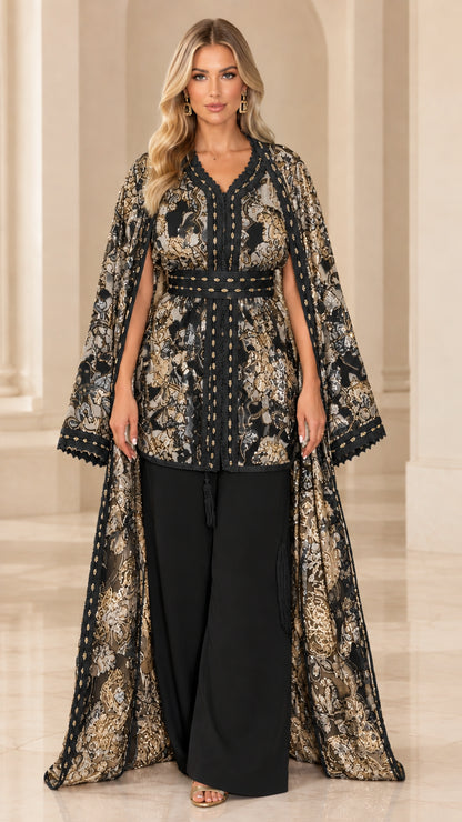 Full-length front view of model wearing Black and gold jacquard cape and pant set