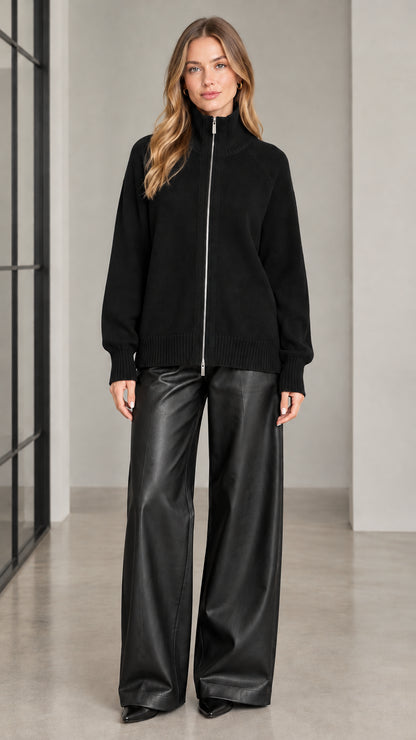 Front view of woman wearing black full zip high neck knit sweater
