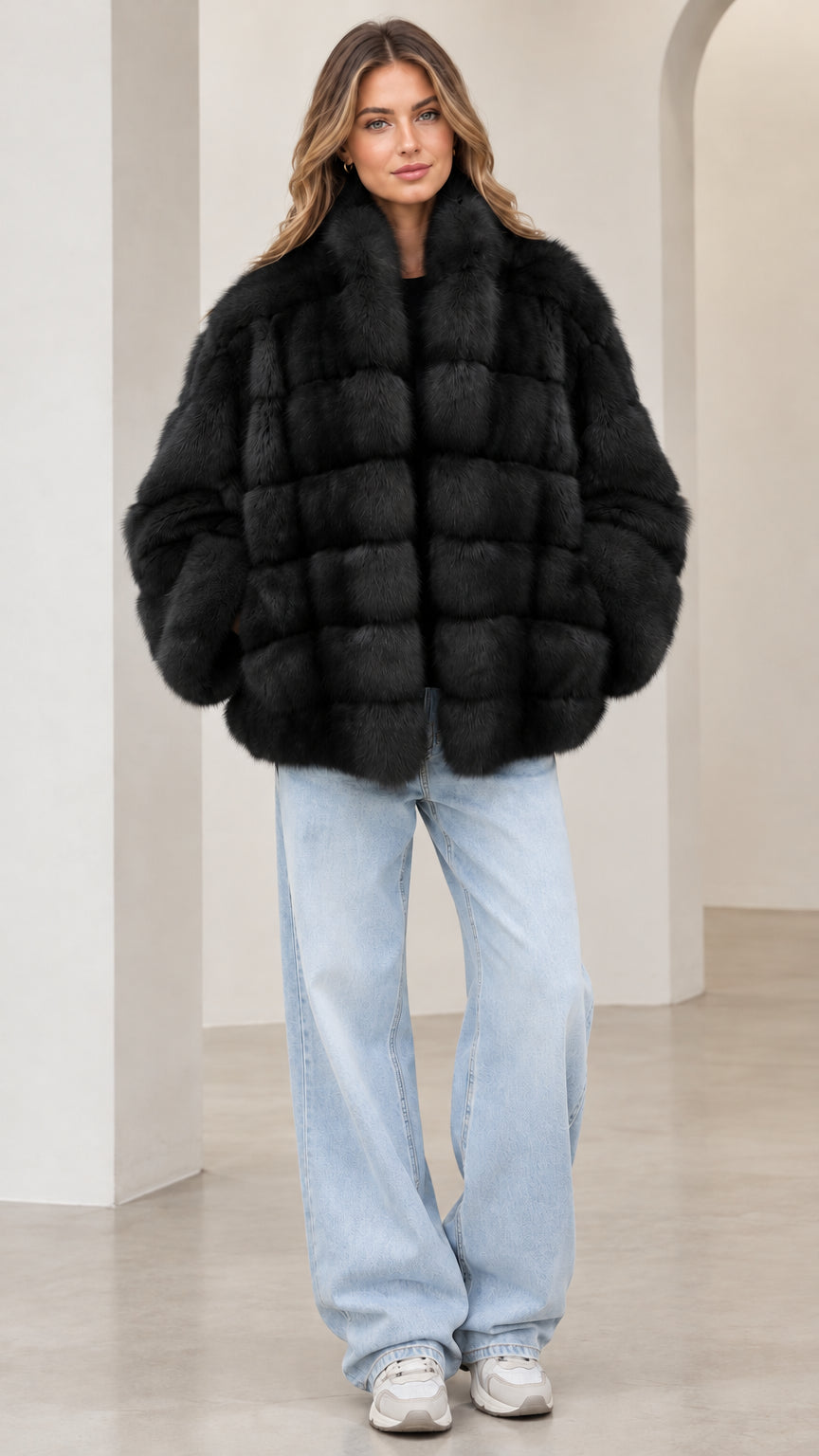 Front view of model wearing the black paneled faux fur jacket